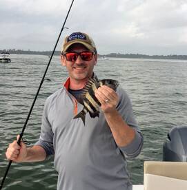 Dad holding sheepshead in Navarre, FL