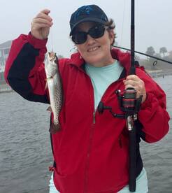 lady in red jacket hold trout Navarre