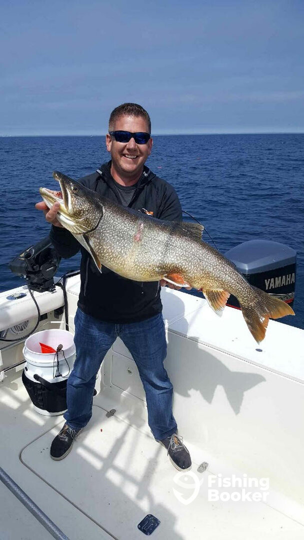 Master Captain Matt holding a 25lb Lake Trout