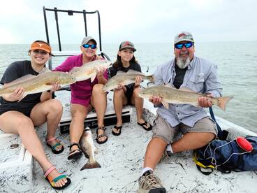 Family fishing on redfish schools winter time.