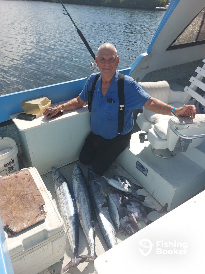 Happy guy with his catch of 3 Wahoo, Trigger fish,