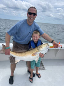 Young fella caught a red bigger than him