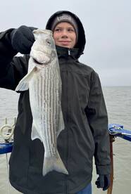 Luke lands his first striped bass